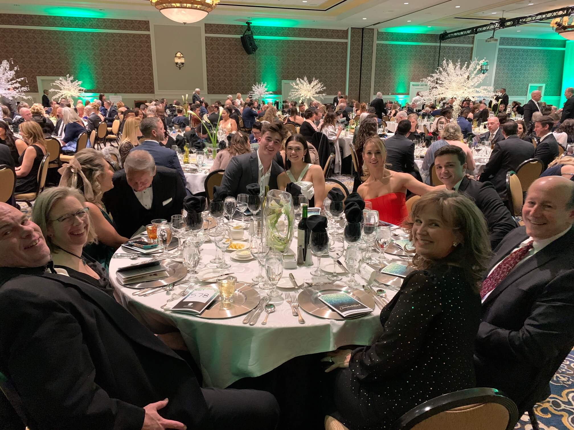 Smiling guests at table at ChocolateBall